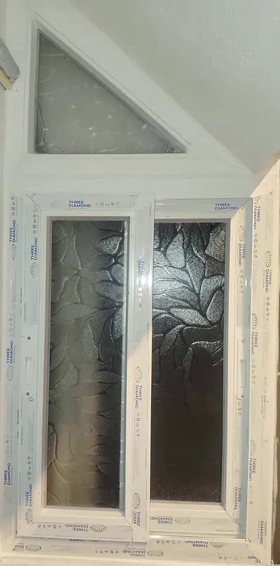 Triangular fixed uPVC light above a sliding window under a staircase